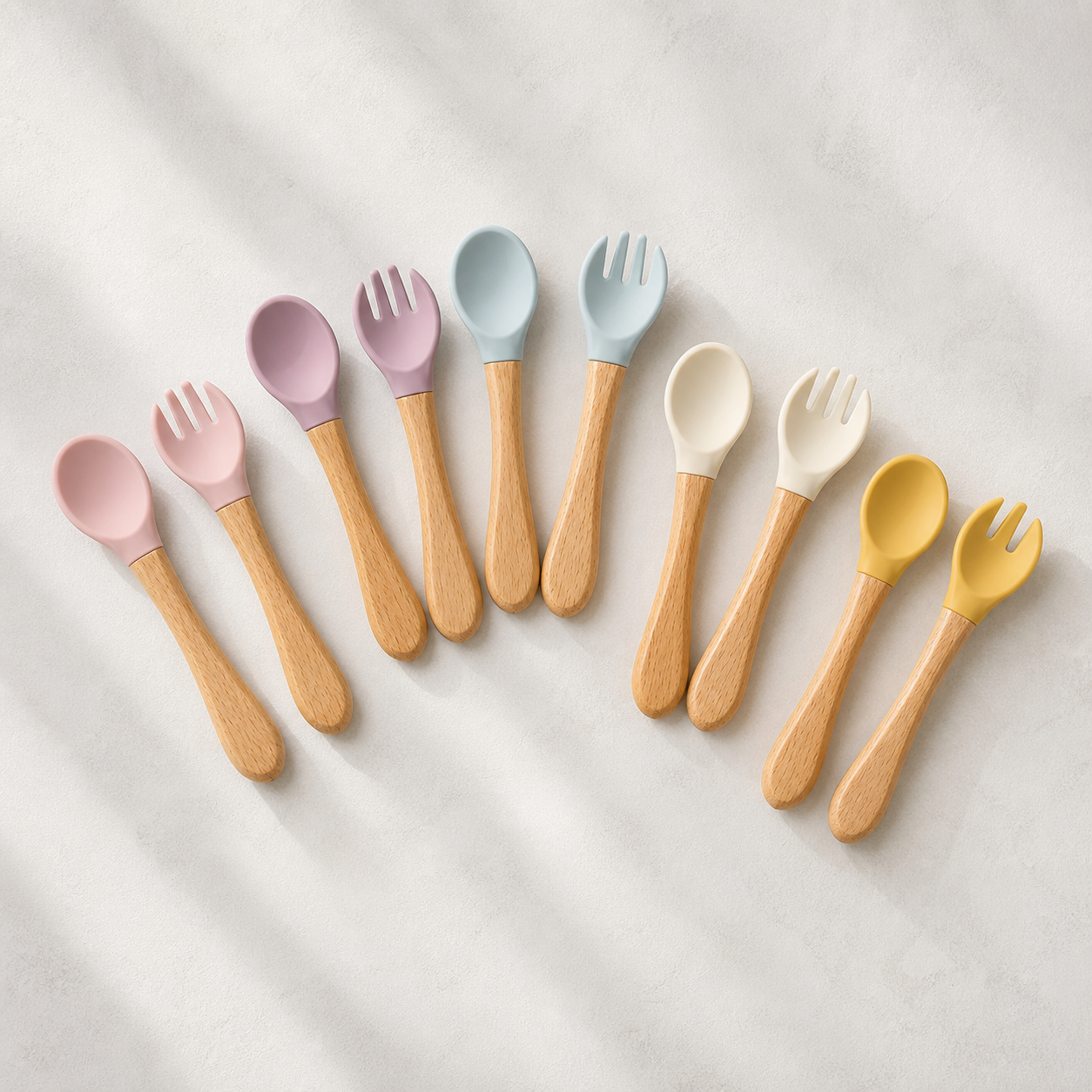 YumBella silicone spoon and fork sets in Powder Rose, Dusty Lilac, Mist Blue, Beach Sand and Mustard
