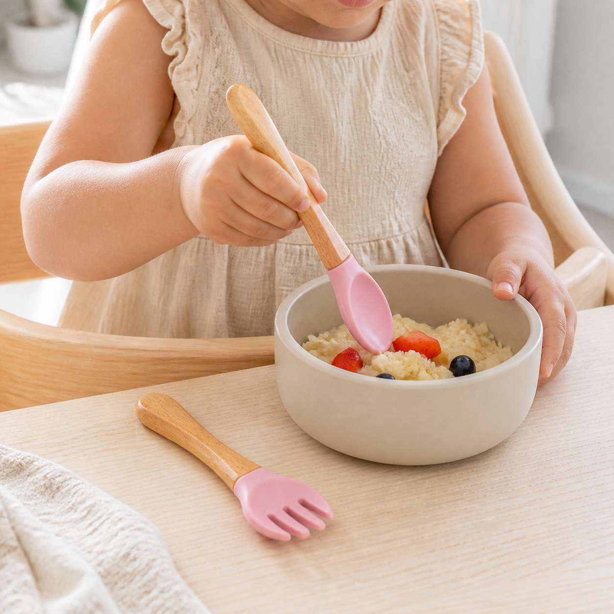 Child using the YumBella silicone spoon at mealtime